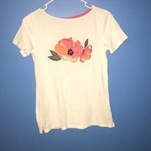 White top with orange flower